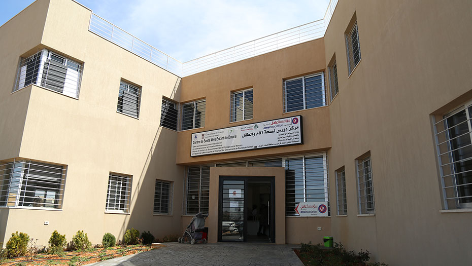 Facade of the Douris Mother and Child Health Center, a building with barred windows.