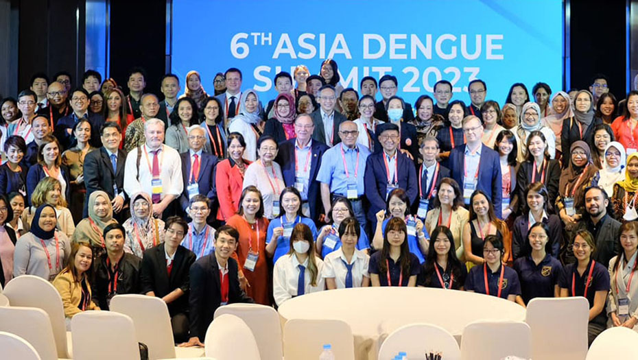 A meeting room in front of a large screen displaying the event title.