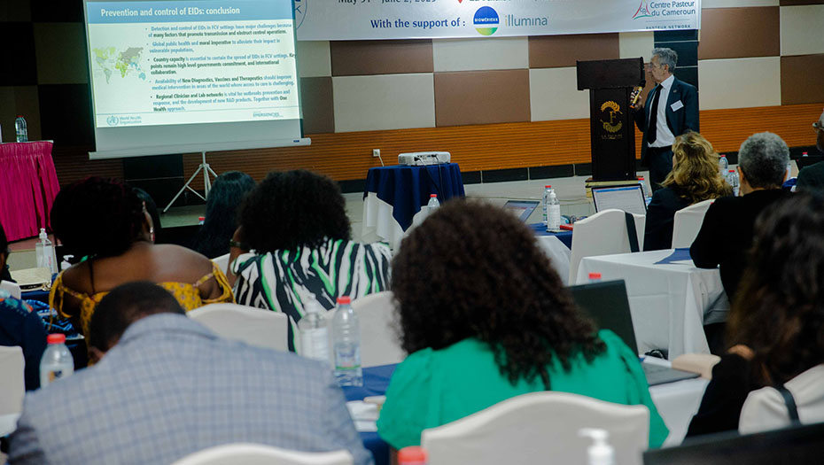 A speaker presents slides at the 12th international meeting of the GABRIEL network, with participants sitting and listening.